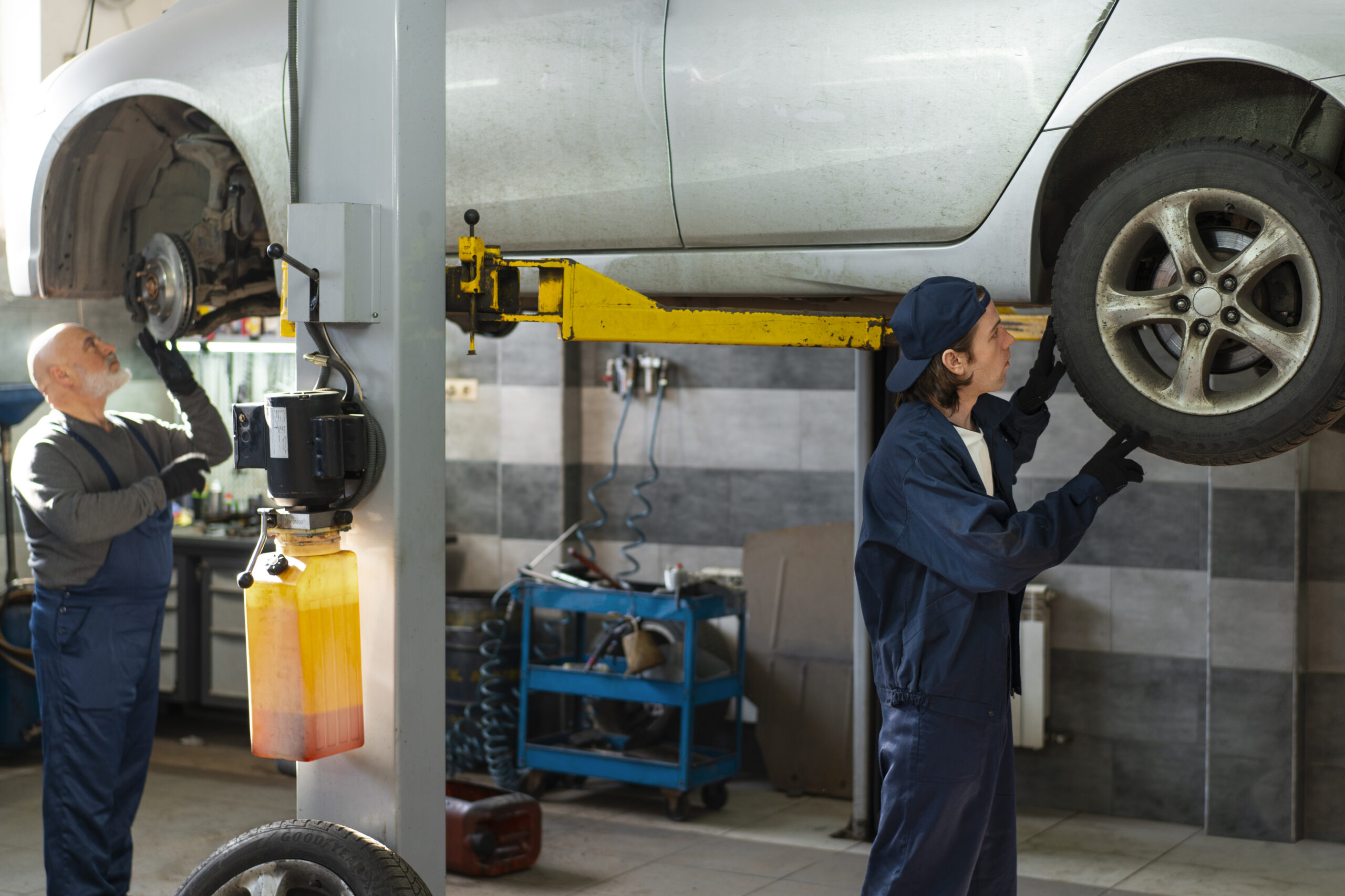 male-car-mechanic-working-car-repair-shop