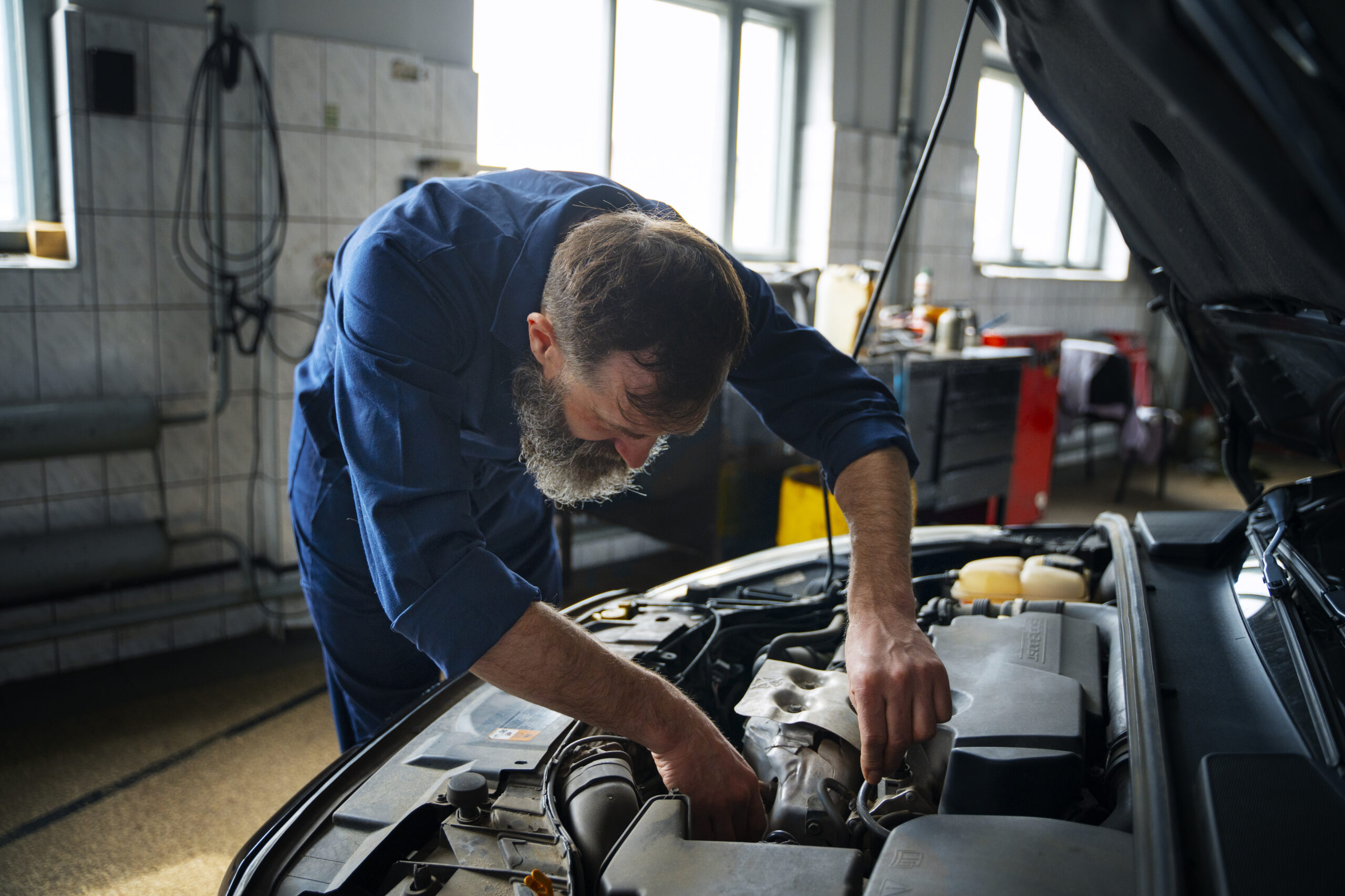 male-mechanic-working-auto-repair-shop-car